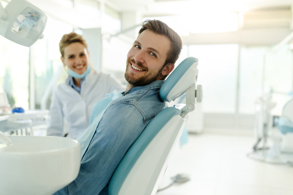 My smile is perfect! Portrait of happy patient in dental chair.